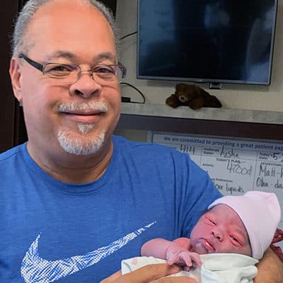  Pictured: Awe Video Athletic Consultant Tommy Wade holds his newborn grandson, Tyson Hector Priess. Wade conducted a sport recruiting service NCSA review and discusses and shares NCSA cost and sales tactics.