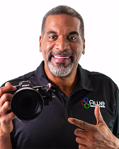 Nkosi Narmer, Owner of Awe Video & Photo Studio, posing with his camera to celebrate the launch of full-service videography, photography, and aerial drone offerings. Why it works: It's shorter, uses strong keywords, and keeps the focus on the new service offerings and the launch.
