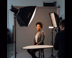 Awe Video & Photo Studio photography services icon image of African American woman sitting down for headshot photo.