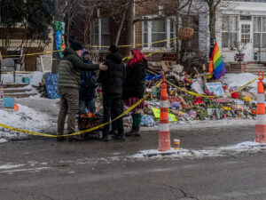 Community members and visitors huddled around an open pit fire at the Renee Good Roadside Memorial in Minneapolis to keep warm during a winter vigil for the slain mother of three, ages 15, 12, and 6. January 20, 2026 (Photo by Awe Video & Photo Studio) Community members and visitors huddled around an open pit fire at the Renee Good Roadside Memorial in Minneapolis to keep warm during a winter vigil for the slain mother of three, ages 15, 12, and 6. January 20, 2026 (Photo by Awe Video & Photo Studio)