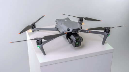 Product Image of the DJI Air 3S drone on pedestal with its navigation lights on. Part of the Awe Video & Photo Studio drone fleet. (Photo by Awe Video & Photo Studio) Professional product image of the DJI Air 3S drone on pedestal with navigation light on, part of the Awe Video & Photo Studio drone fleet. (Photo by Awe Video & Photo Studio)
