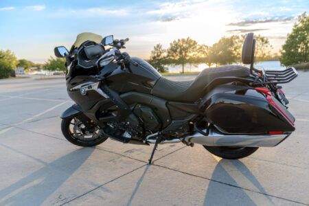 BMW K1600 B: Nkosi's getaway. An Image of a black 2024 K1600 B parked in front of scenic Big Creek Lake located in Polk City, IA.